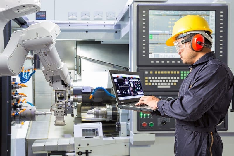 Factory floor with machinery and workers in safety gear
